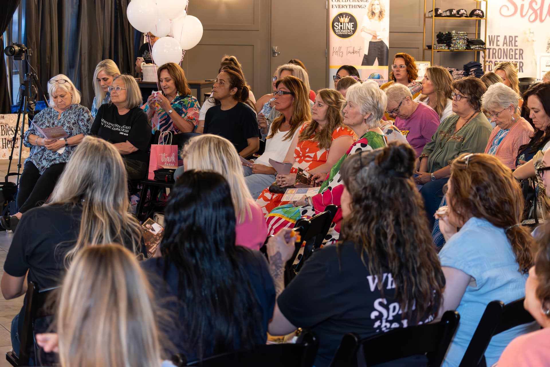 Women seated together in worship at the Shine Women's Conference